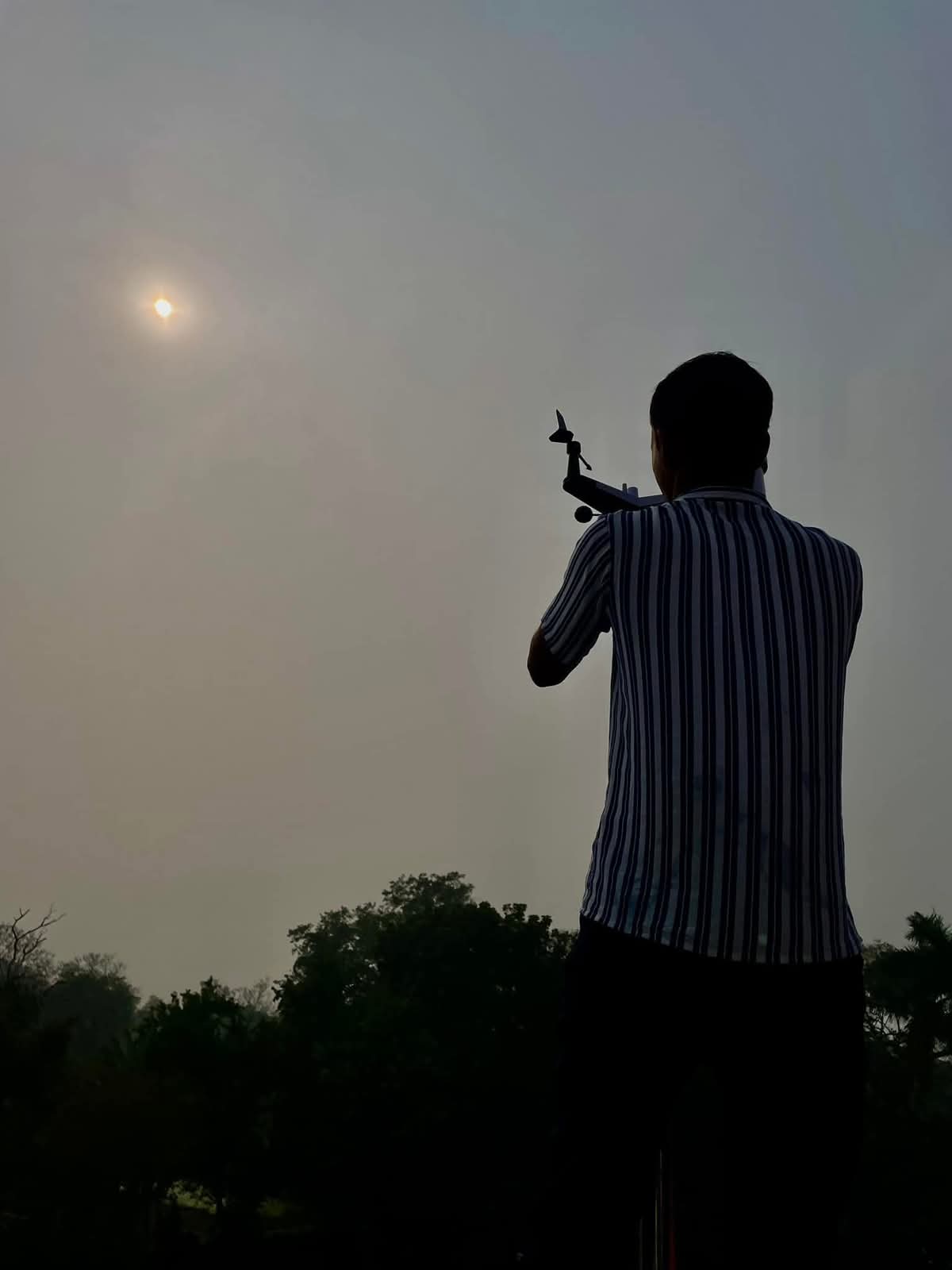 Rabindra Goenka observing the sky with a weather instrument